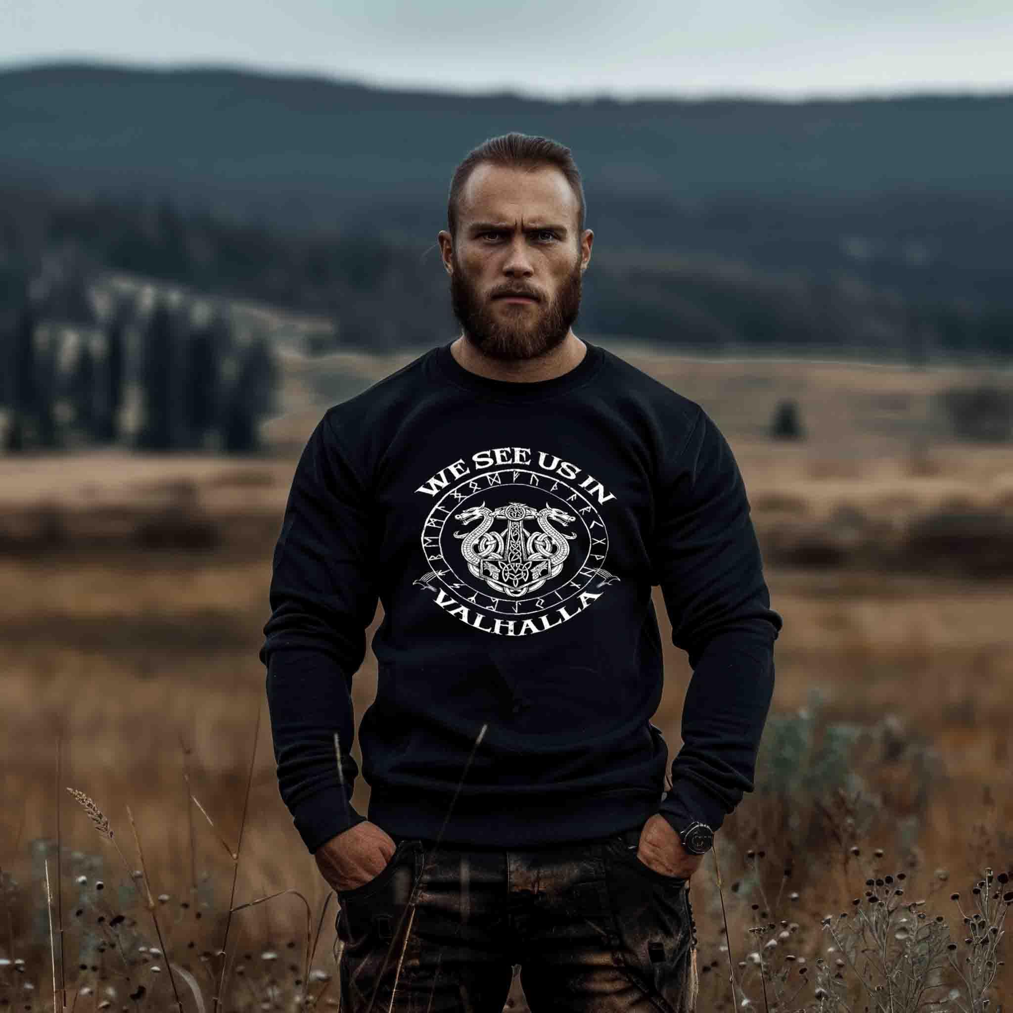 Mann im Wikinger Pullover mit 'We See Us In Valhalla' Motiv, Naturkulisse, nordischer Stil