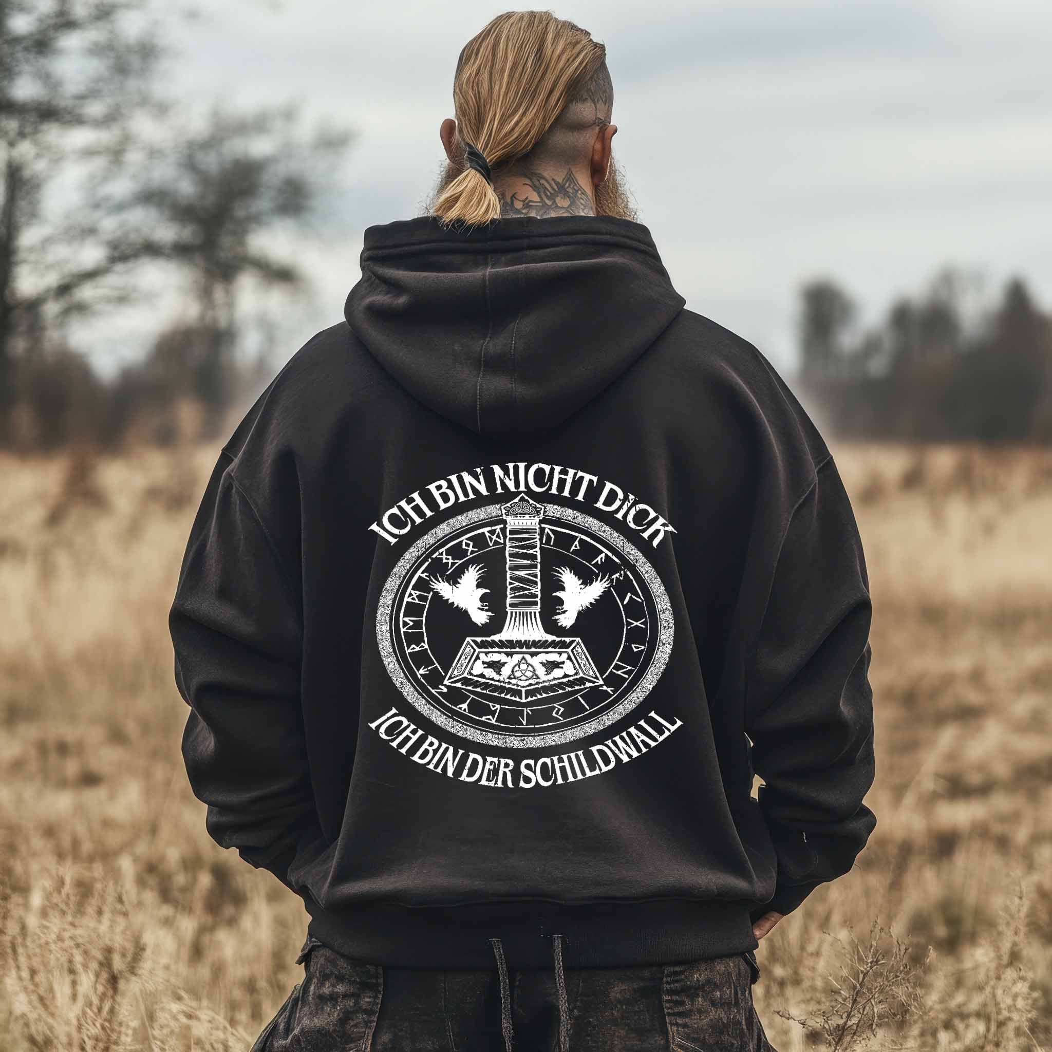 Man wearing Wikinger Oversized Hoodie Schildwall 3.0 with Thors Hammer and runic circle design showing Viking pride and humor